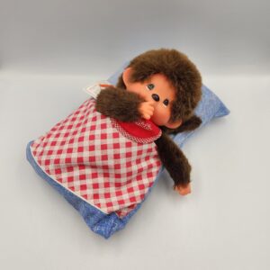 Vintage Sekuguchi Monchhichi Boy with Bib, 11 inch tall in sleeping bag *with original tags*; thumb sucking Monchichi boy plush