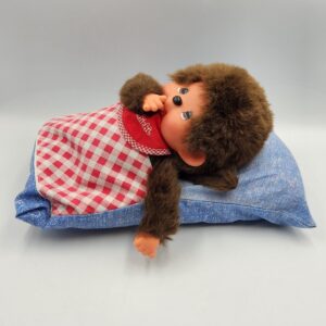 Vintage Sekuguchi Monchhichi Boy with Bib, 11 inch tall in sleeping bag *with original tags*; thumb sucking Monchichi boy plush